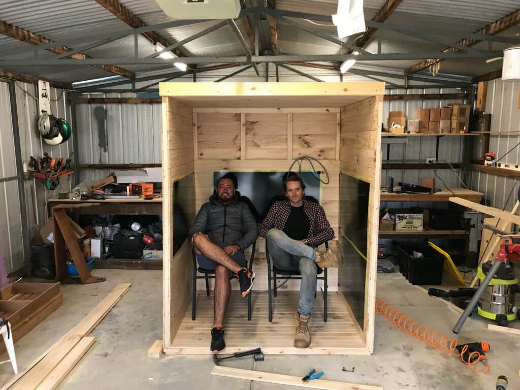 SaunaCloud team reviewing a custom sauna build in the workshop