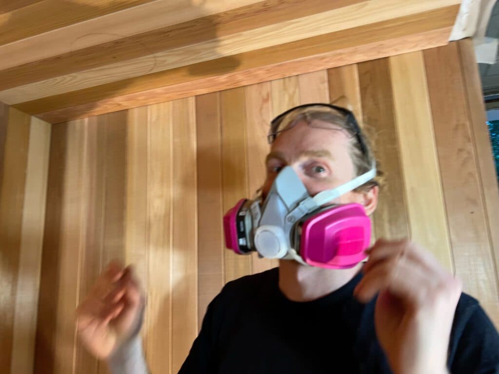 Craftsman fitting cedar panels for a custom infrared sauna